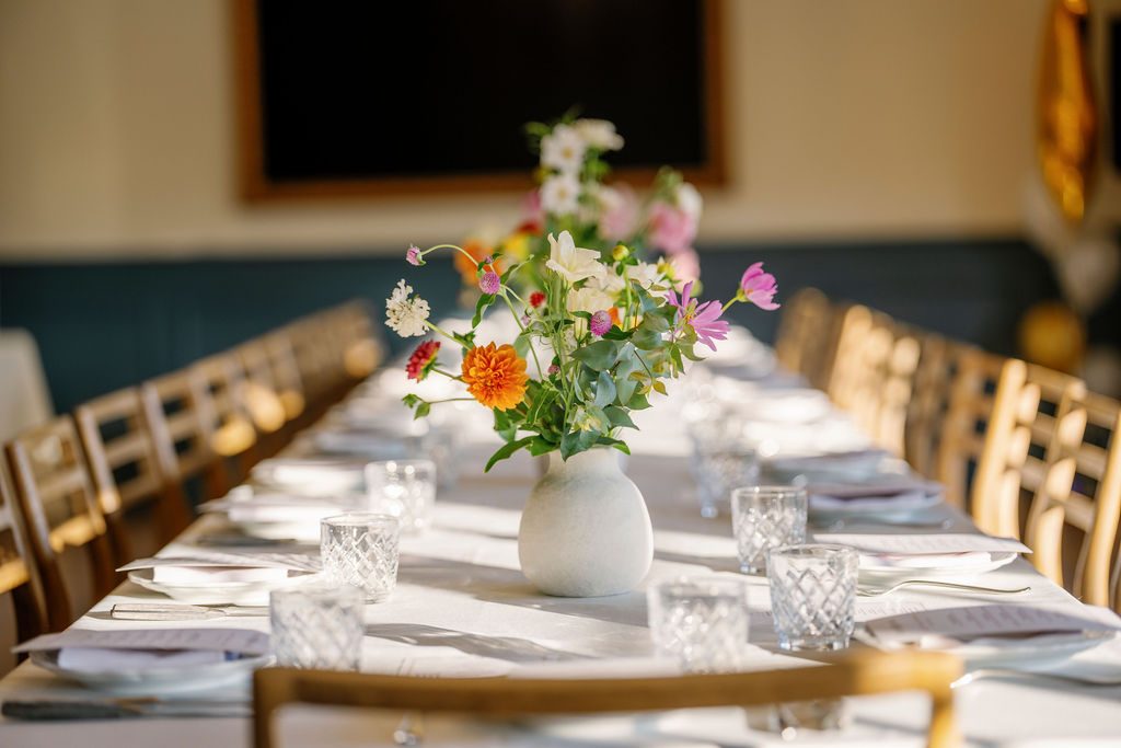 A table set in The Drawing Room with the Frame TV mounted on the wall